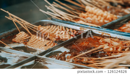 Traditional Chinese Meat Snacks On Bamboo Sticks. Fried Squid, M 126124826