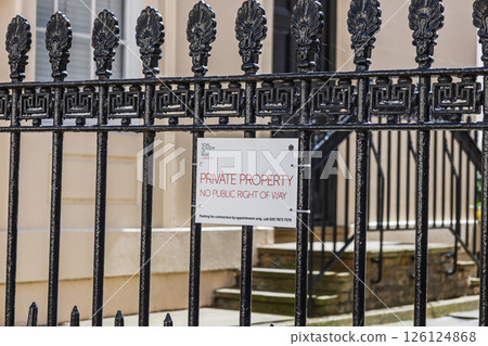 Iron Gate with Private Property Sign Restricting Access to Residential Area 126124868