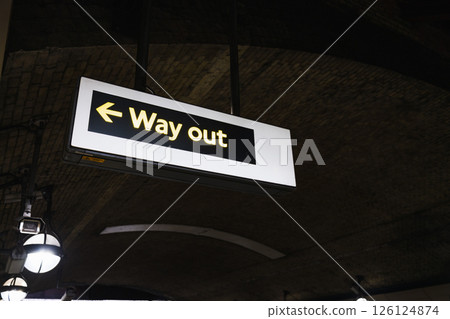 London Underground Station - Way Out - Sign Illuminated in Dark Tunnel Environment 126124874