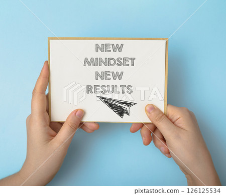Hand holding a card with the words New Mindset, New Results written on it 126125534