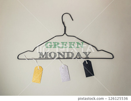 Clothes hanger with tags on it that say Green Monday 126125536