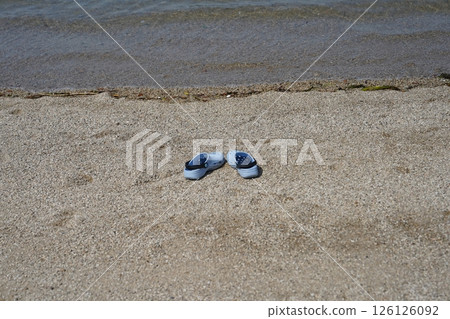 Sandals washed up on the beach Sandals washed up on the beach 126126092