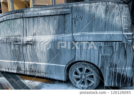 A minivan being washed with foam 126126093