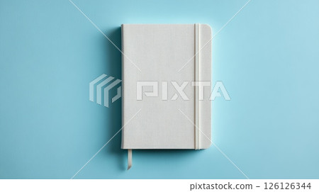 White Hardcover Notebook on Blue Background for Design Concepts and Creativity 126126344