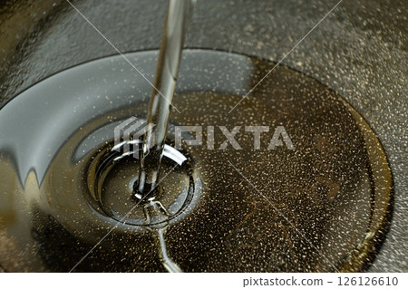 Vegetable oil poured into cast iron pan macro process. 126126610