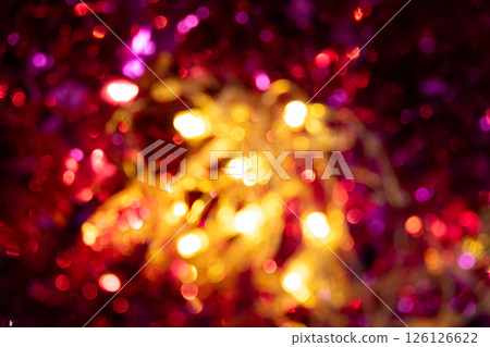 Festive blurred Christmas background, shimmering garland and Christmas tree, bokeh. Festive blurred Christmas background, shimmering garland and Christmas tree, bokeh. 126126622