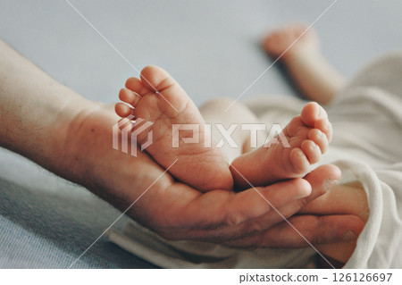Mom's arms hug the baby. the legs of a newborn. the heels, the fingers of a baby, a child. Childbirth, maternity capital, artificial insemination, IVF, mortgage, family, love. High quality photo Mom's arms hug the baby. the legs of a newborn. the heels, the fingers of a baby, a child. Childbirth, maternity capital, artificial insemination, IVF, mortgage, family, love. High quality photo 126126697