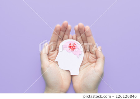 Hands holding human head with brain as pain red circle on purple background. Concept of headache, stroke disease, migraine, epilepsy, meningitis, brain tumor and dementia. Mental health. Hands holding human head with brain as pain red circle on purple background. Concept of headache, stroke disease, migraine, epilepsy, meningitis, brain tumor and dementia. Mental health. 126126846
