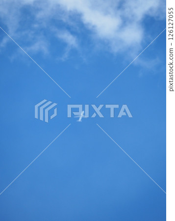 The plane flying high in the blue sky is pure white The plane flying high in the blue sky is pure white 126127055