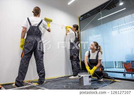 Group of housekeeping staff painting the walls in the office Group of housekeeping staff painting the walls in the office 126127107