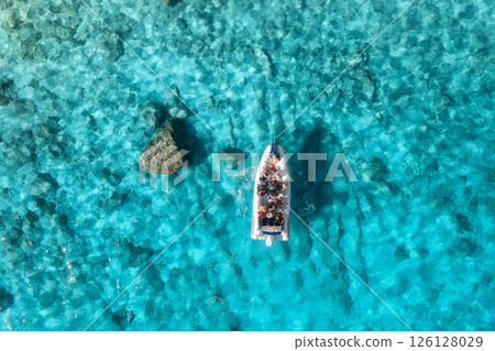 Aerial view of boat with people in clear blue sea in summer Aerial view of boat with people in clear blue sea in summer 126128029