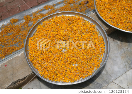 Petals of marigold flower on  a tray 126128124