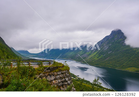 Road across of Rocky Mountain in Norway with clouds 126128392