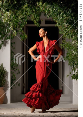 Flamenco dancer performing with passion in red dress 126128513