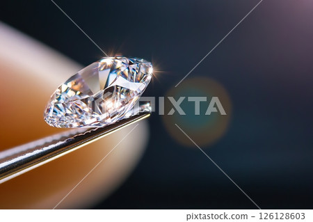 Tweezers holding a sparkling diamond, luxury and precision Tweezers holding a sparkling diamond, luxury and precision 126128603