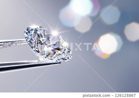 Tweezers holding a sparkling diamond, luxury and precision 126128867
