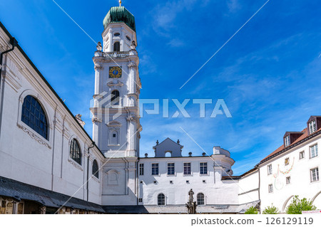 St. Stephans cathedral in Passau, Germany is an old white church with green metal domes on top of the towers 126129119