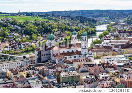 St. Stephans cathedral in Passau, Germany is an old white church with green metal domes on top of the towers St. Stephans cathedral in Passau, Germany is an old white church with green metal domes on top of the towers 126129128