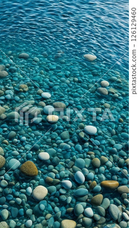 Clear turquoise water with smooth pebbles underwater. Tranquil seaside scenery. Natural stone texture in crystal clear sea 126129460