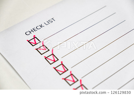 checklist with red check marks on paper  126129830
