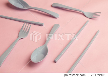Background of Cutlery such as spoon, fork, chopsticks made of Gray plastic with Pink Background Background of Cutlery such as spoon, fork, chopsticks made of Gray plastic with Pink Background 126129906