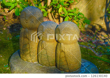 Three Jizo statues standing close together 126130140