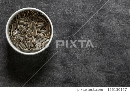sunflower seeds pile against in bowl  126130157