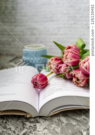 Pink tulips, an open book and a mug of freshly brewed coffee or tea. Spring set. Flatley layout 126130492