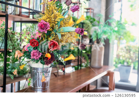 Artificial flower bouquet decor on table at cafe and restaurant 126130595