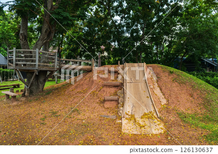 Slider and wood tree house in child playground of cafe and restaurant 126130637