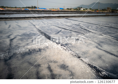 Salt crystallization process underway at Asian fields near village using natural evaporation Salt crystallization process underway at Asian fields near village using natural evaporation 126130677