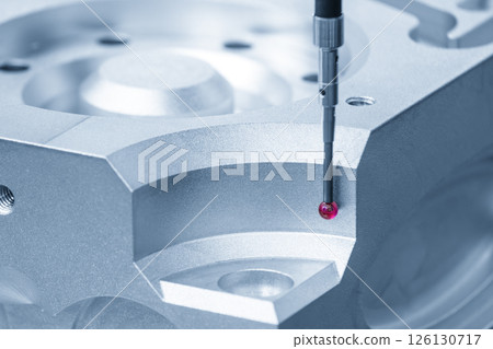 The CMM machine measuring the aluminum parts in the light blue scene. 126130717