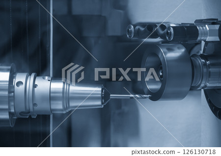 The drill tool regrinding machine control by CNC program in the light blue scene. 126130718
