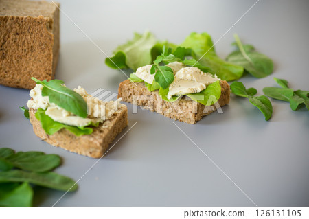 Isolated sandwich with rye bread and herring on the background 126131105