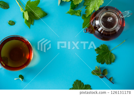Green tea from currant and mint leaves in a glass teapot Green tea from currant and mint leaves in a glass teapot 126131178