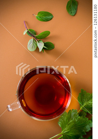 Herbal drink with mint and currant in transparent cup 126131180