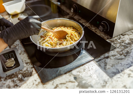 Cooking Pasta with Care A Culinary Delight, Serving as a Delicious Joy for Dinner and Sharing 126131201