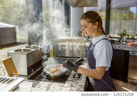 A Young Cook Prepares a Delicious Meal in a Modern Kitchen with Various Ingredients 126131208