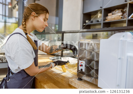 A skilled barista brews delicious coffee with top equipment in a modern cafe ambiance 126131236