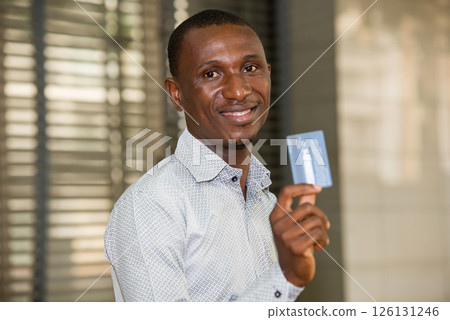 close up of young man, smiling. 126131246