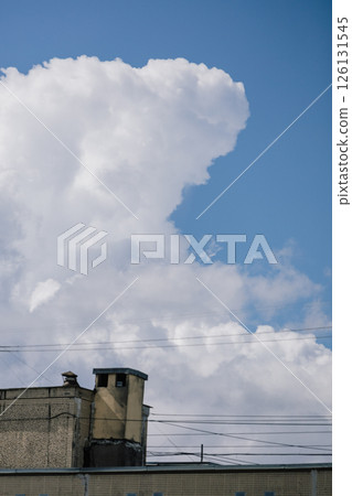 Fluffy white cloud in the blue sky. clear and cloudy weather, possible precipitation, rain. Fluffy white cloud in the blue sky. clear and cloudy weather, possible precipitation, rain. 126131545