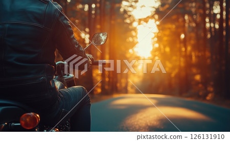 Motorcyclist Riding On Desolate Forest Road At Sunrise 126131910