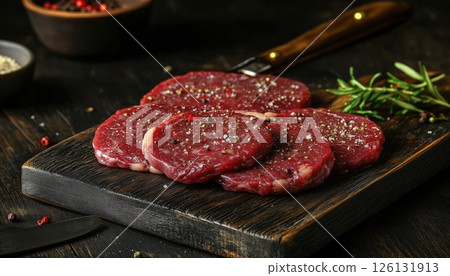 Assorted Raw Beef Steaks For Grilling With Seasoning And Tools On Dark Rustic Cutting Board Assorted Raw Beef Steaks For Grilling With Seasoning And Tools On Dark Rustic Cutting Board 126131913
