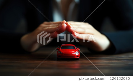 Businesswoman Protects Red Toy Car On Desk 126132080