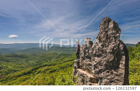 Woman Tourist Standing on Edge of Mountain Cliff Woman Tourist Standing on Edge of Mountain Cliff 126132597