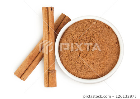 Cinnamon sticks with powder in ceramic bowl isolated on white background. Top view. Flat lay. 126132975