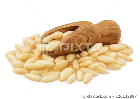 Shelled European pine nuts in wooden scoop isolated on white background with full depth of field Shelled European pine nuts in wooden scoop isolated on white background with full depth of field 126132987