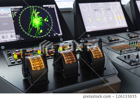 Modern ship control panel with radar screen and digital navigation units 126133035