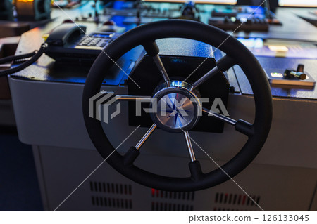 Marine navigation simulator. A detailed view of the ships helm Marine navigation simulator. A detailed view of the ships helm 126133045