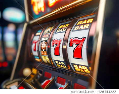 Close-up of slot machine reels showing winning 777 combination 126133222